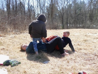 the boys wrestling in a meadow