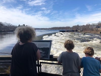 the boys looking down at water roaring over a dam on the Merrimack River