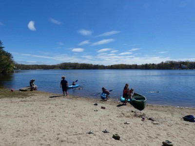 boats and kids on the beach at Freeman Pond