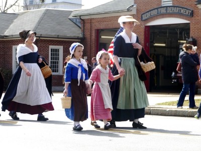 colonial women and girls walking in the parade