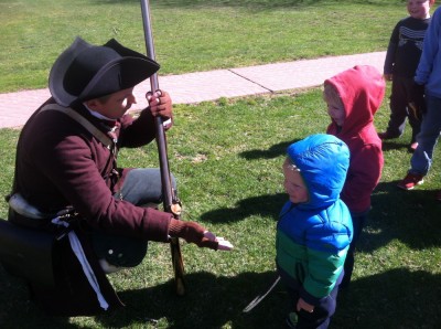 a reenactor offering to shake hands with Lijah and Zion