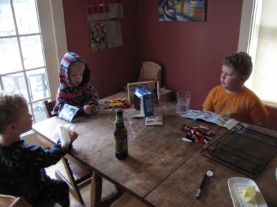 the three boys working on legos at the kitchen table