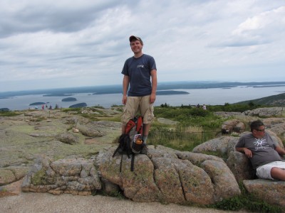 Dan standing on top of Cadillac Mtn, with Frenchmans Bay and the Schoodic Peninsula in the background