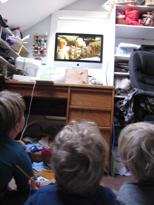 the boys watching a movie in the messy office/sewing room