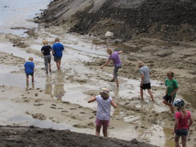 kids wading out into the mud