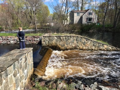 water pouring over the spillway from Warners Pond into Nashoba Brook