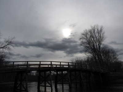bare trees and gray sky behind the Old North Bridge