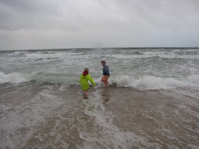 Harvey and Zion wading in the stormy ocean