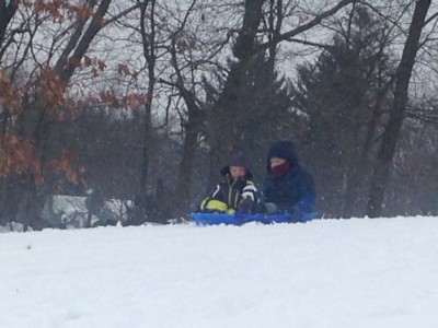 Harvey and Zion sledding in the snow