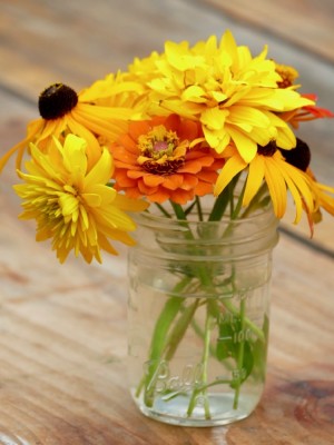 yellow and orange flowers in a jar