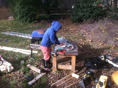 Harvey working on a woodworking project in the messy corner of our yard
