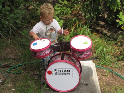 Lijah playing the drum kit outside