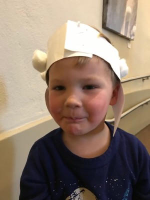 Lijah in a paper and cotton-ball sheep hat