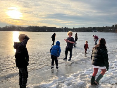 kids standing and talking on the ice on Freeman Lake