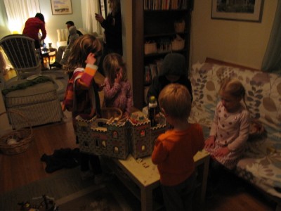 smaller kids playing with the castle inside in the warm