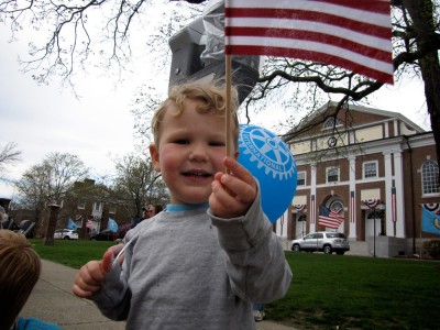 Lijah waving a flag along the parade route
