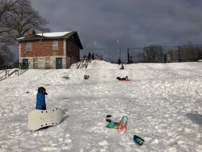 Zion and Elijah sledding down the hill at park day