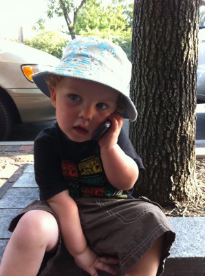Harvey sitting on the sidewalk talking on the phone