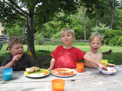 backyard picnic with Zion reaching for Lijah's food