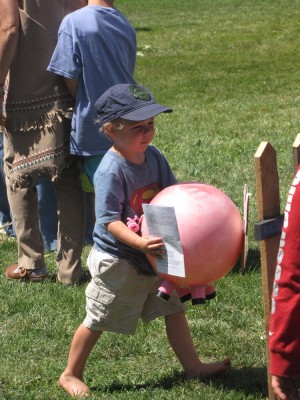 Zion carrying a pink pig ball