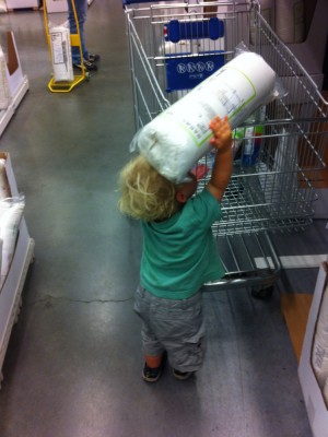 Zion putting his new pillow into the shopping cart