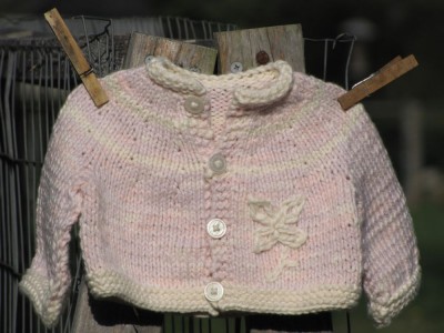 pink cotton sweater on clothes pins