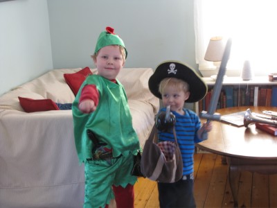 the boys posing in the living room: Harvey dressed as Peter Pan and Zion as a pirate