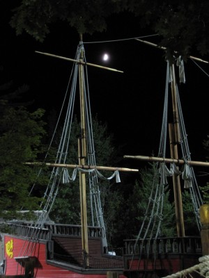 the moon over the rigging of the golf course pirate ship