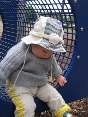 harvey plays on the playground with his new hat