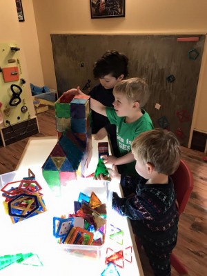 Zion, Lijah, and Julen building at Learning Express