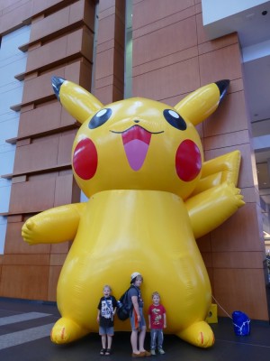 the boys posing in front of a gigantic inflatable Pikachu