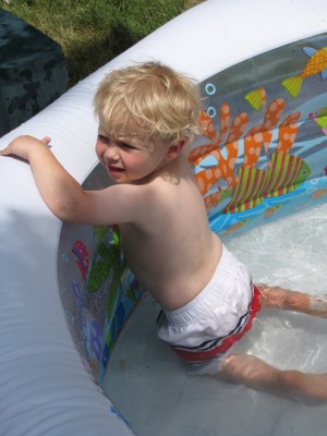 Zion clinging to the side of the inflatable wading pool
