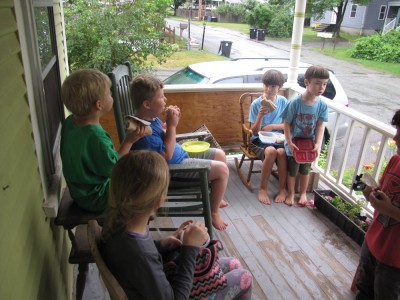kids eating lunch on the porch on a rainy day