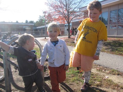 the boys posing outside the polling place with their stickers on