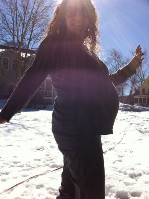 Leah and her belly silhouetted by the winter sun