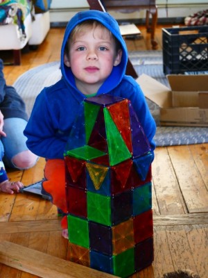 Zion posing behind his magnetile structure