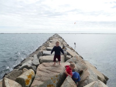 the boys braving the wind on the breakwater in Provincetown