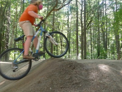 Harvey going over a dirt hill on a pump track