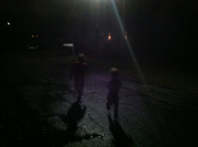very dark: Harvey and Zion, in swimsuits, running in the rain at night