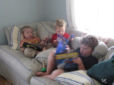 three boys on the couch with three books