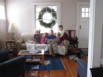 Grandpa reading to Nisia and the boys on his couch