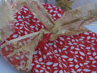 a cloth-wrapped, gold-ribboned present