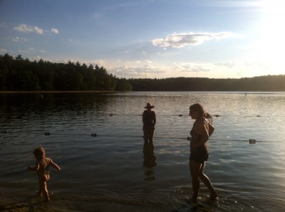 naked lijah walking with Mama in the shallow water at Walden