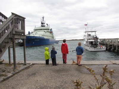 Zion, Harvey, Matthew and Sam looking at the research ships in the harbor at Woods Hole