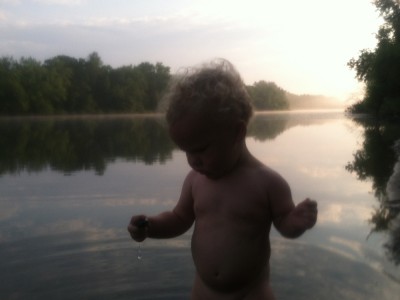 Lijah playing in the river, with morning mist