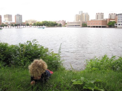 Harvey lying down and crying beside the Charles River