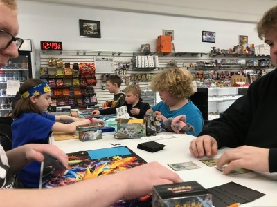 Zion and Harvey playing Pokemon at a prerelease event
