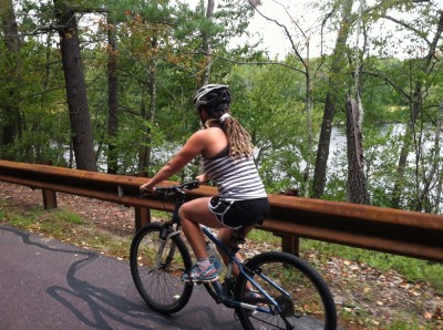 Leah riding her mountain bike by Flint Pond