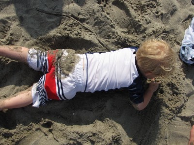 zion lying on his stomach in the sand