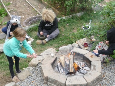 kids toasting marshmallows and mashing acorns in our backyard